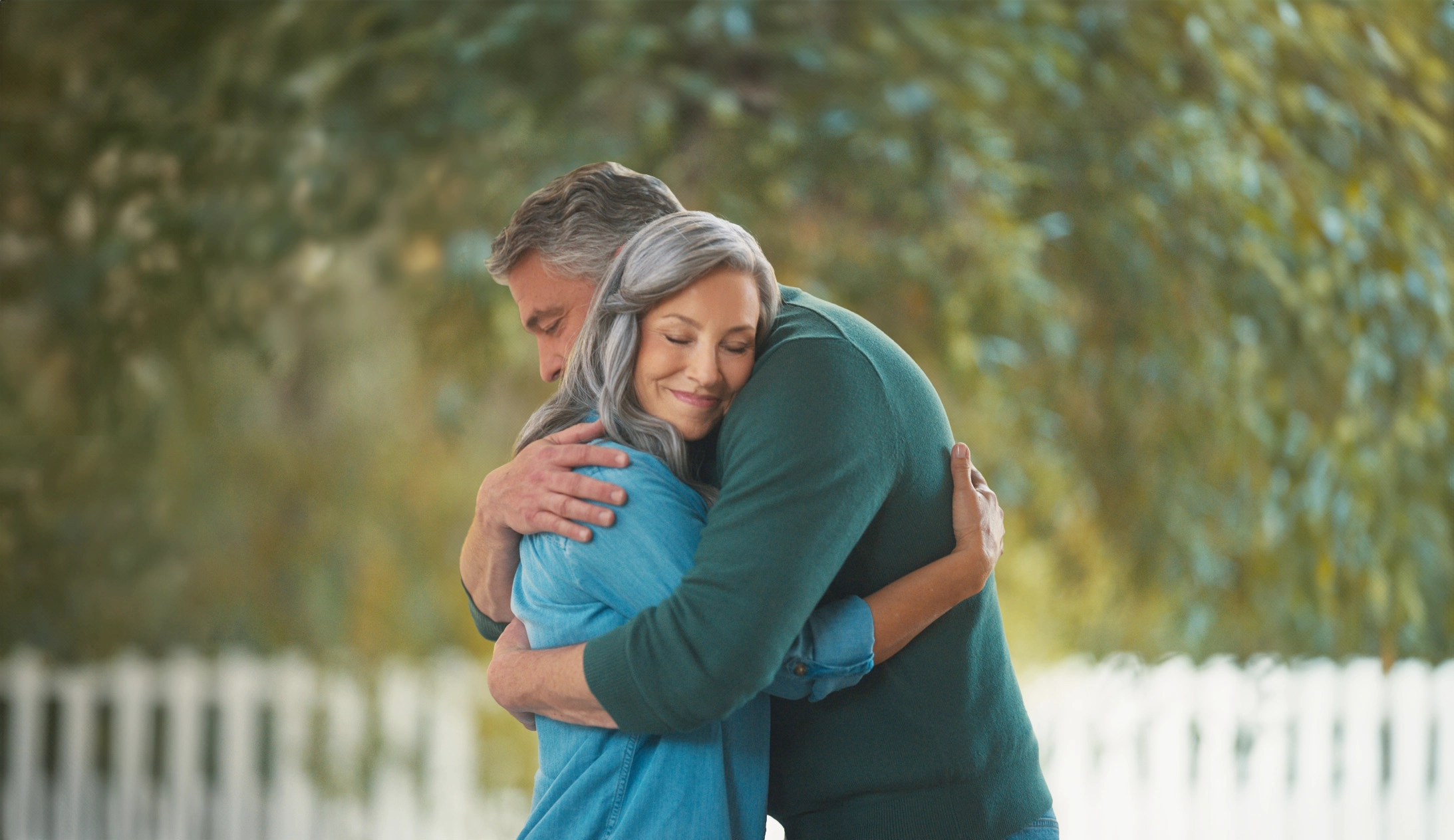 man smiling looking at a laptop screen