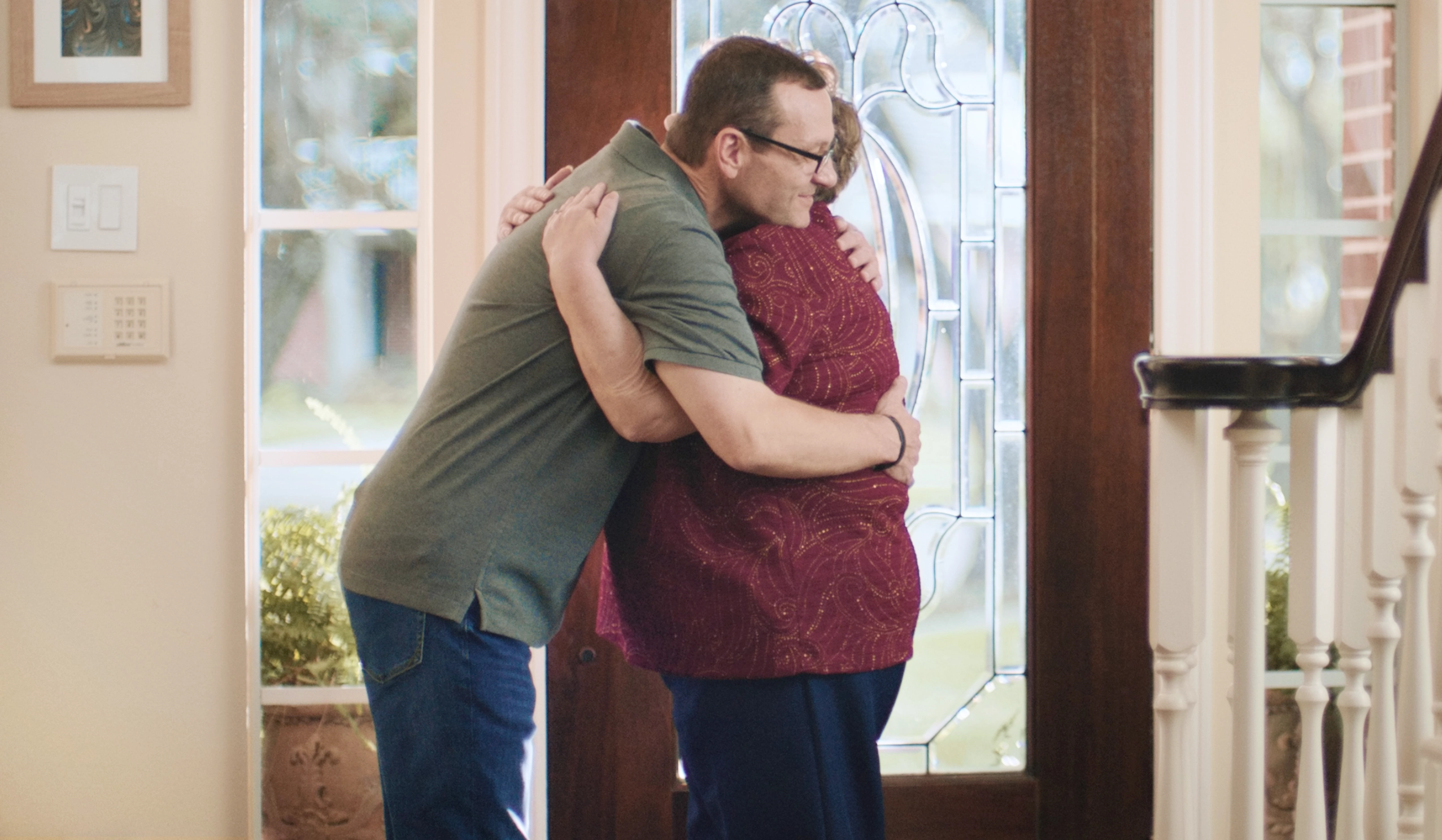 man smiling looking at a laptop screen