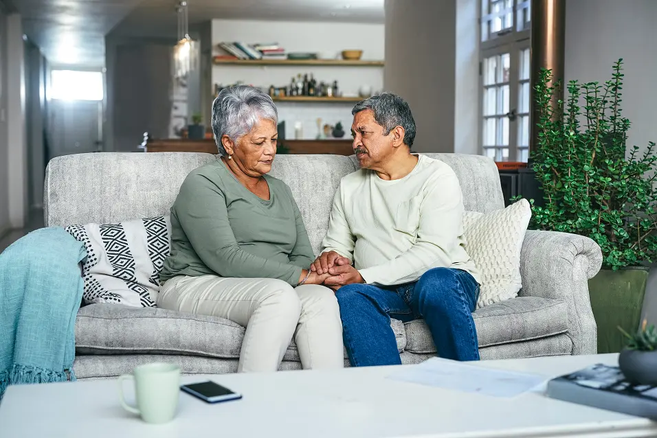 Man and woman sitting on a couch talking